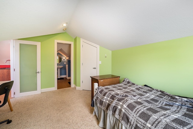 carpeted bedroom with vaulted ceiling