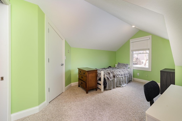 carpeted bedroom featuring vaulted ceiling