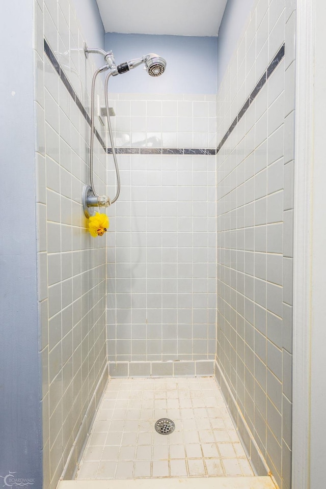 bathroom with tiled shower