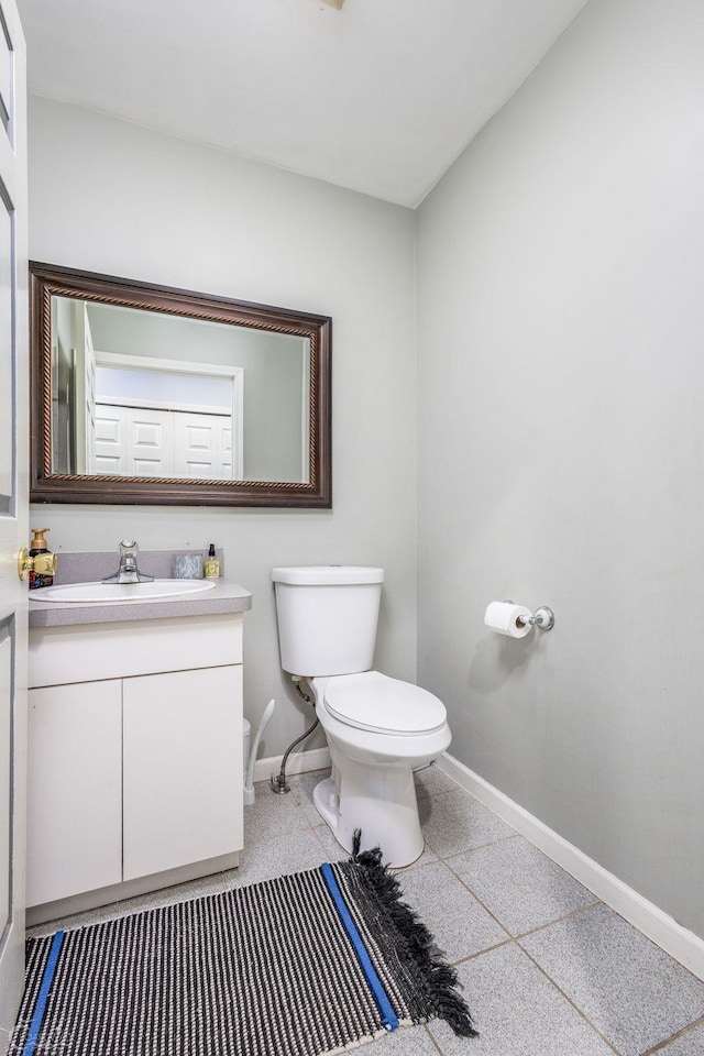 bathroom featuring toilet and vanity