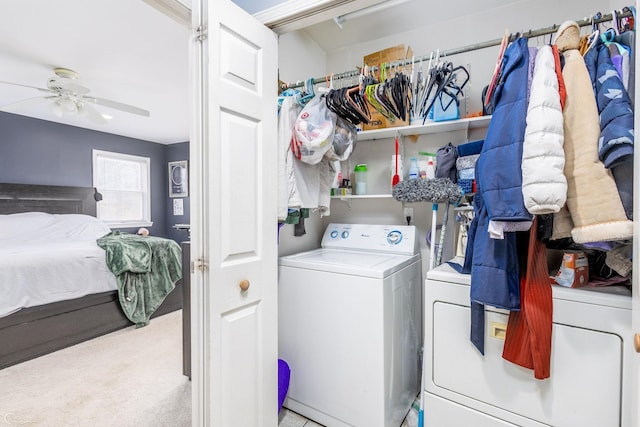 washroom featuring ceiling fan, washer and clothes dryer, and light carpet