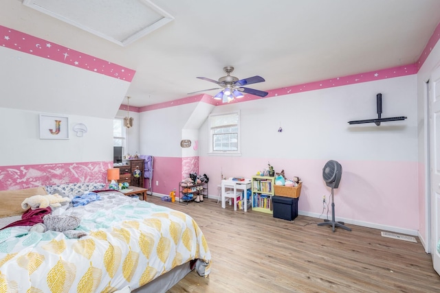 bedroom with ceiling fan, vaulted ceiling, and wood-type flooring