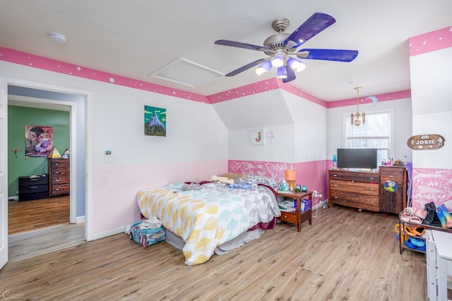 bedroom with ceiling fan, light hardwood / wood-style flooring, and lofted ceiling