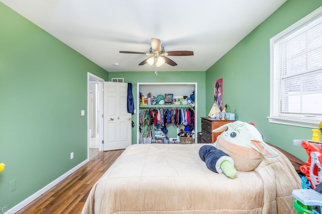 bedroom with wood-type flooring, a closet, and ceiling fan