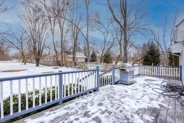 snow covered deck featuring grilling area