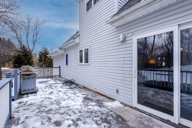 snow covered deck featuring area for grilling