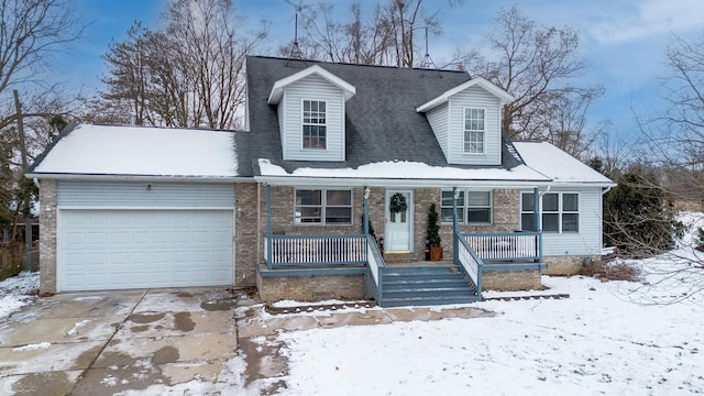 cape cod house with a garage and covered porch