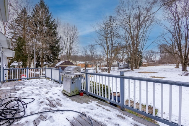 snow covered deck featuring a grill