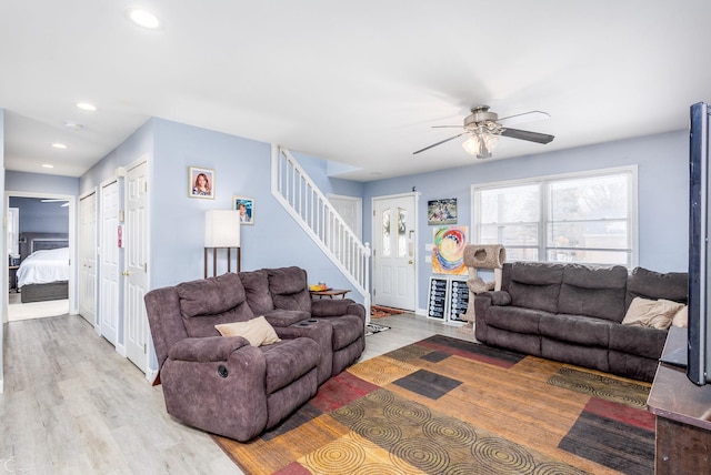 living room with ceiling fan and light hardwood / wood-style floors