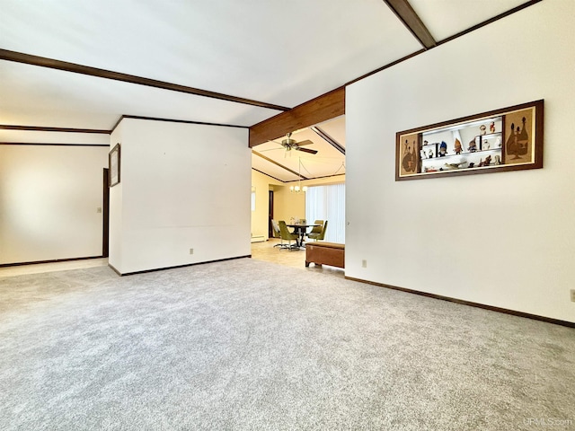 carpeted spare room with lofted ceiling with beams and a chandelier