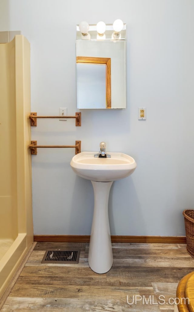 bathroom featuring walk in shower and hardwood / wood-style floors