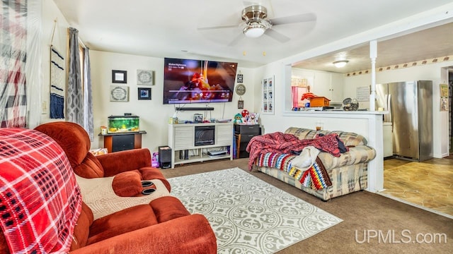 living room featuring carpet floors and ceiling fan