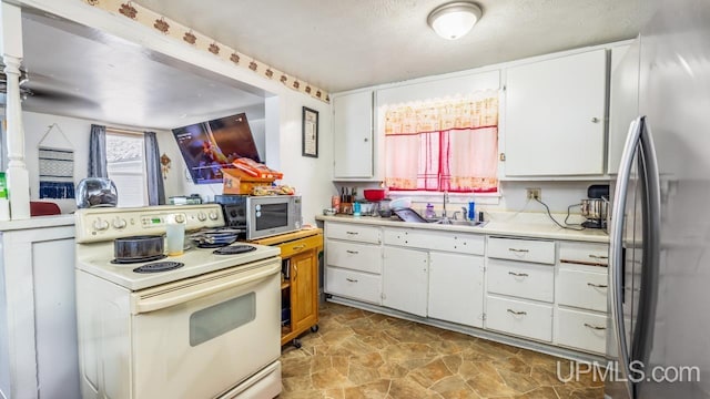 kitchen featuring sink, white cabinetry, and appliances with stainless steel finishes