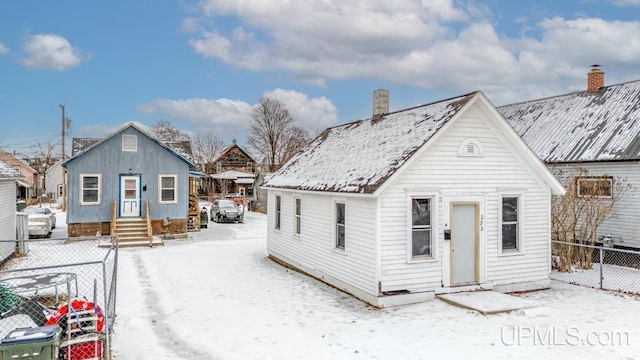 view of snow covered rear of property