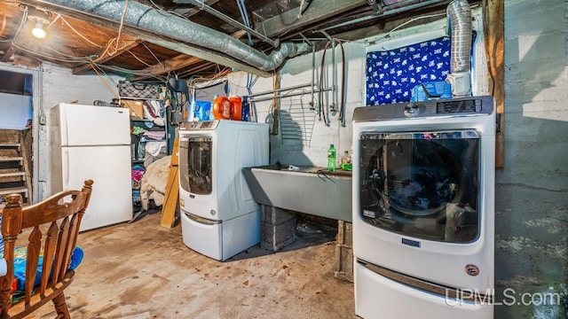 clothes washing area with sink and washer and dryer