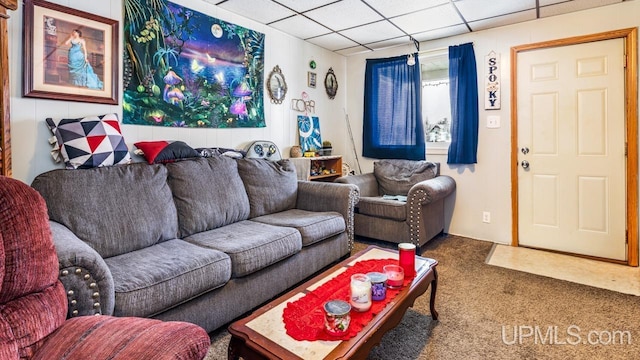 living room featuring a paneled ceiling and carpet floors