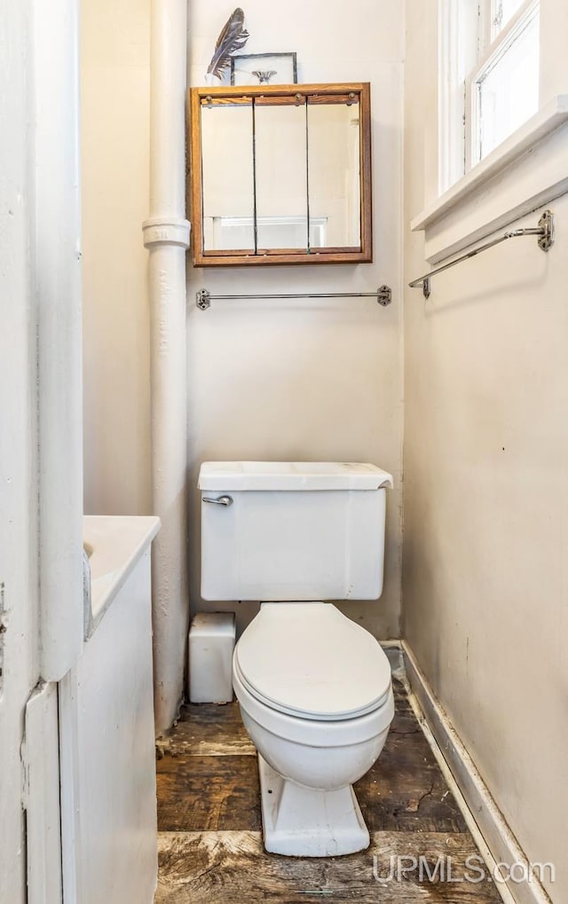 bathroom featuring toilet and wood-type flooring