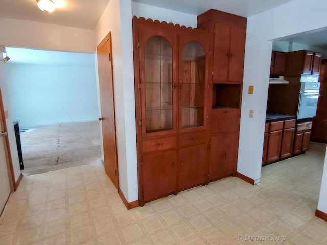 kitchen featuring ventilation hood and oven