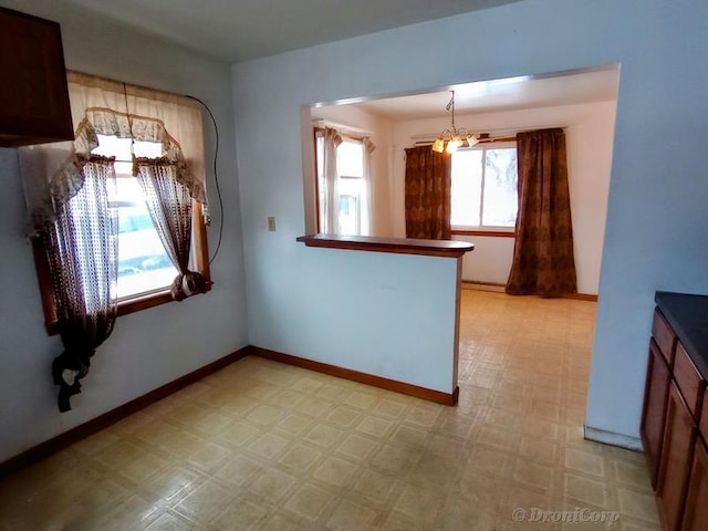 unfurnished dining area featuring a chandelier