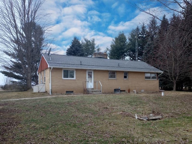 rear view of house with a yard