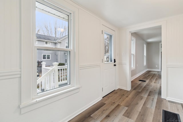 entryway featuring a wealth of natural light and light hardwood / wood-style flooring