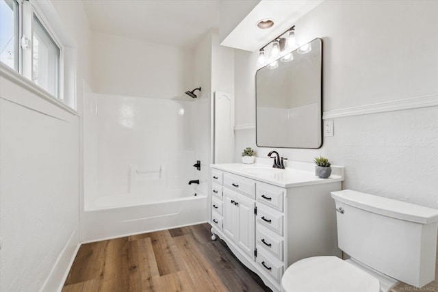 full bathroom featuring vanity, shower / tub combination, toilet, and wood-type flooring