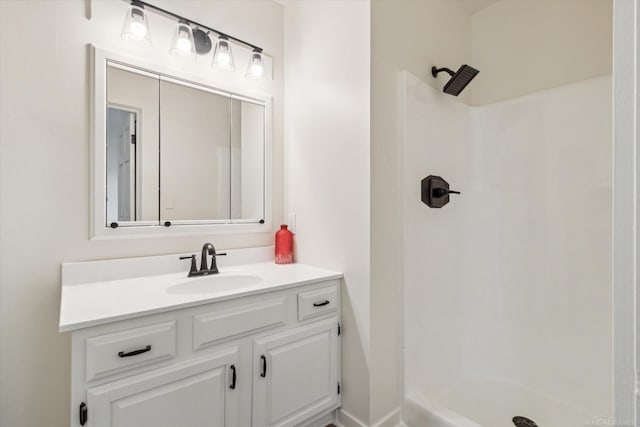 bathroom with a shower and vanity