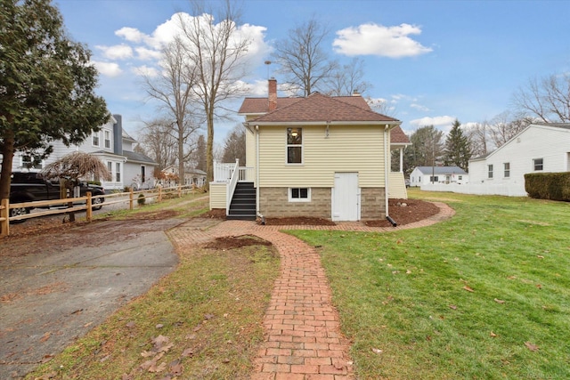 back of house with a lawn