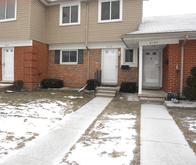 view of snow covered property entrance