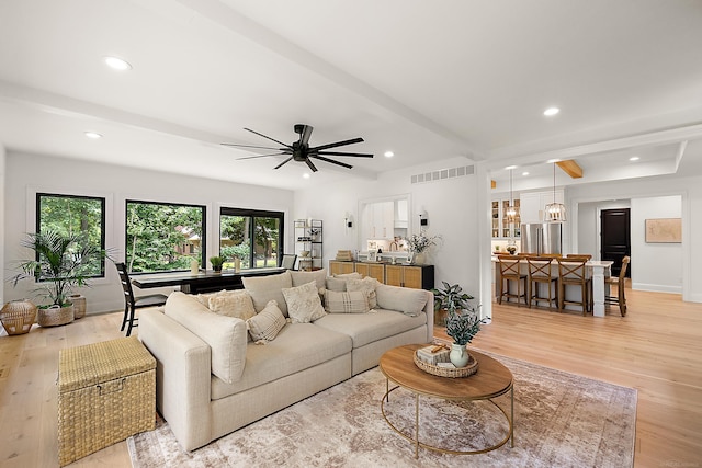 living room with beam ceiling and light hardwood / wood-style floors