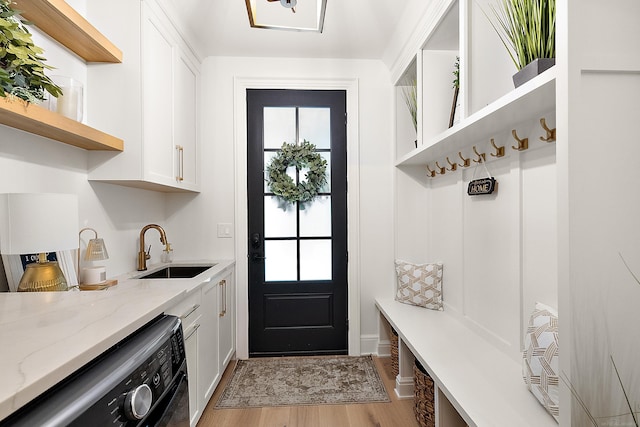 mudroom featuring sink and light wood-type flooring