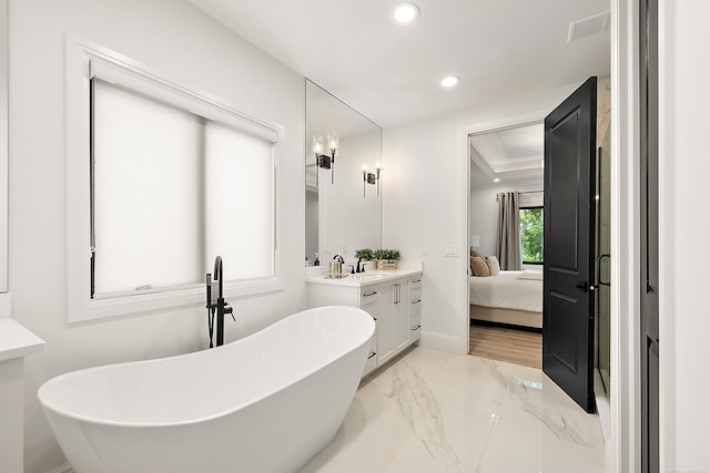 bathroom with a bathing tub and vanity