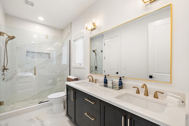 bathroom with vanity, toilet, and a shower with door