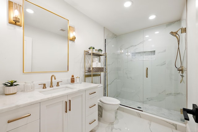 bathroom featuring vanity, toilet, and a shower with door