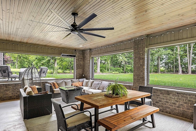 sunroom / solarium featuring ceiling fan and wood ceiling