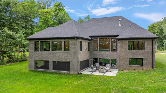 back of property featuring a patio and a yard