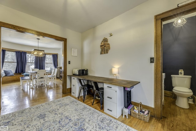 office featuring an inviting chandelier and light hardwood / wood-style flooring