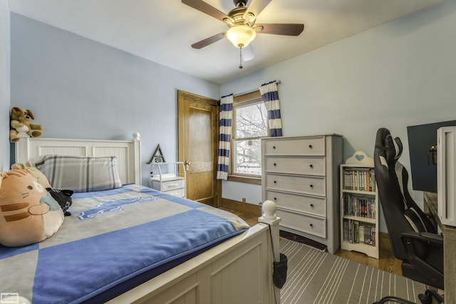 bedroom with dark wood-type flooring and ceiling fan