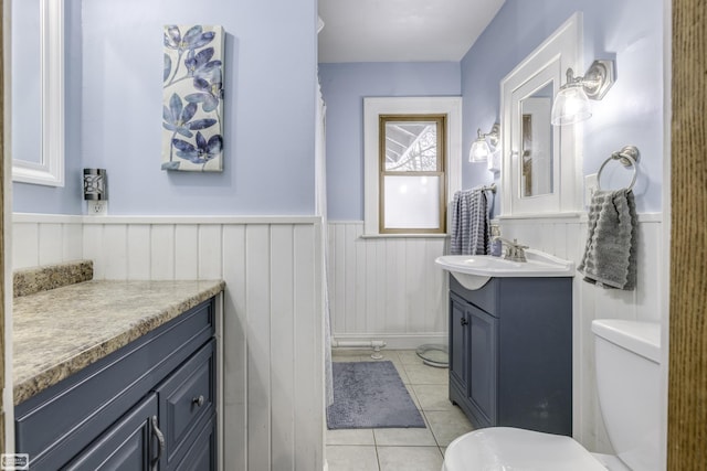 bathroom with tile patterned flooring, vanity, and toilet