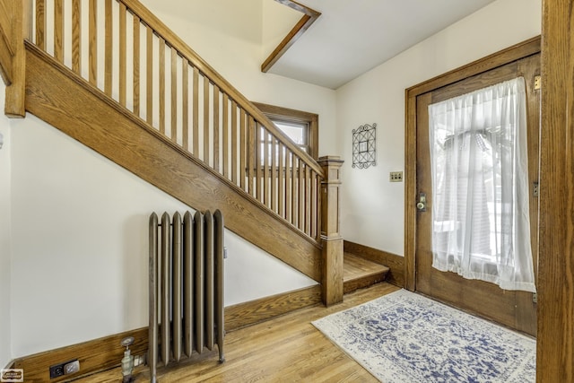 entrance foyer with radiator and light hardwood / wood-style flooring