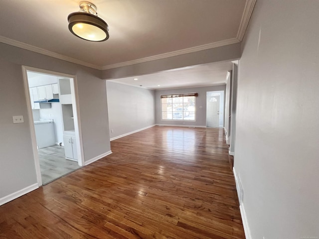 spare room with crown molding and hardwood / wood-style floors