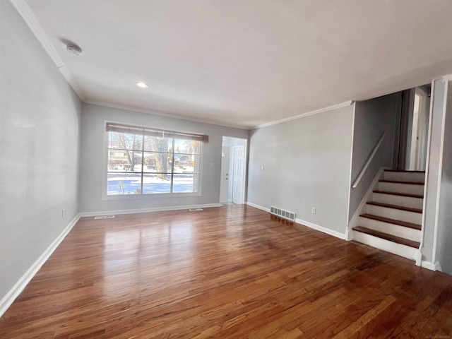 unfurnished living room with crown molding and dark wood-type flooring