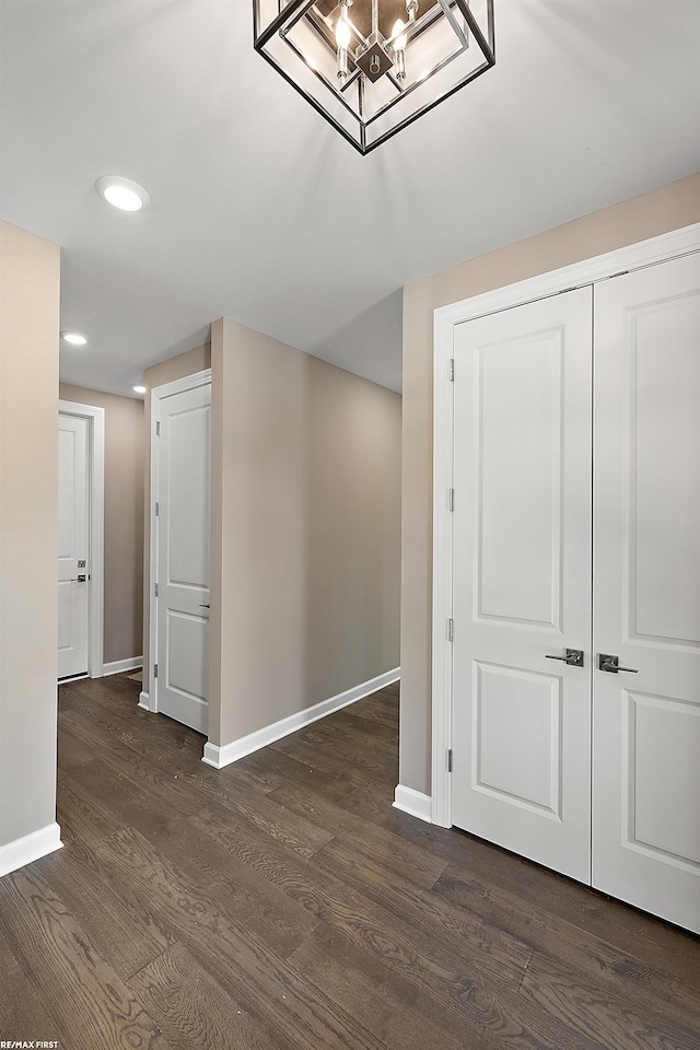 interior space featuring an inviting chandelier and dark hardwood / wood-style flooring