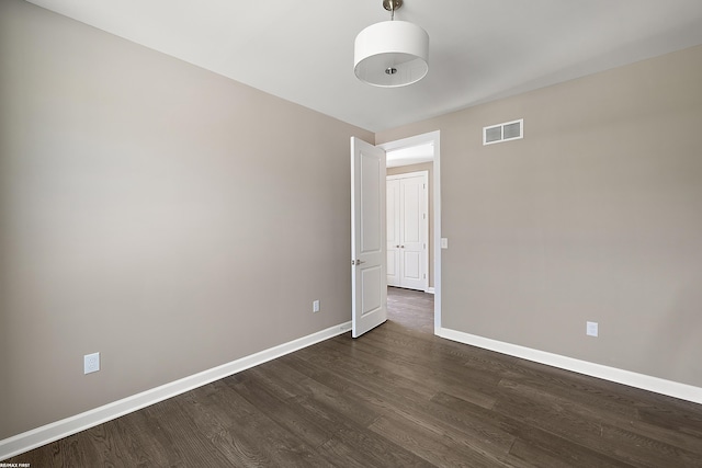 spare room featuring dark hardwood / wood-style floors