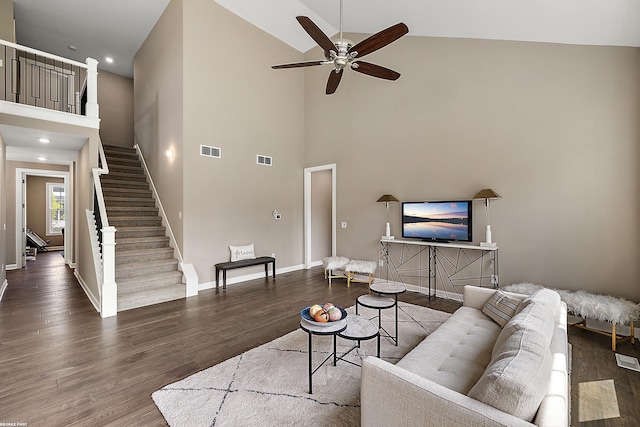 living room featuring hardwood / wood-style flooring, ceiling fan, and high vaulted ceiling