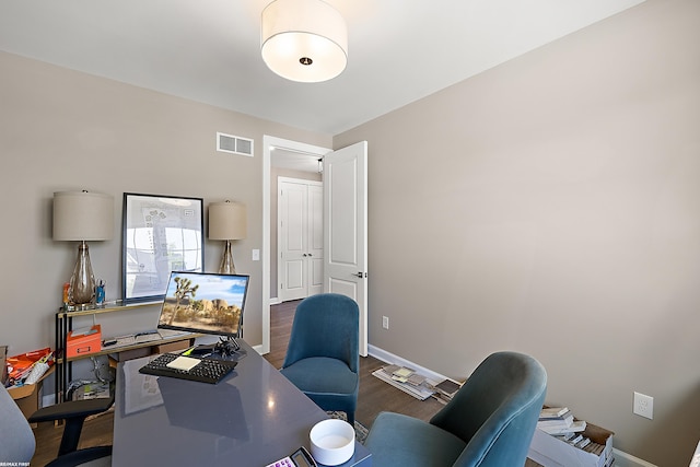 home office with dark wood-type flooring