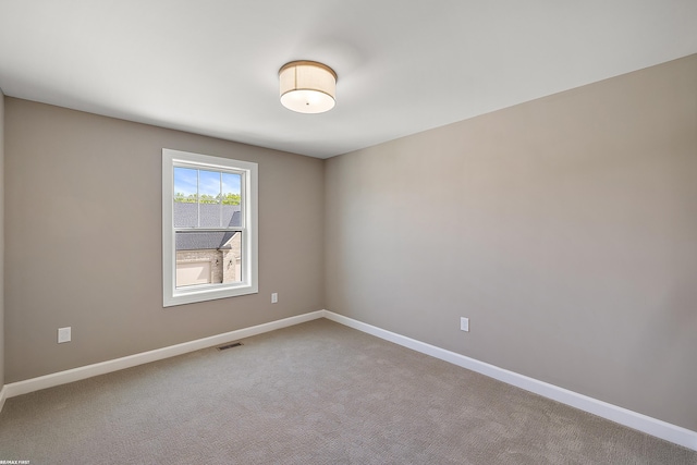 unfurnished room featuring carpet