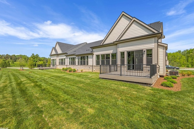 rear view of property with a lawn