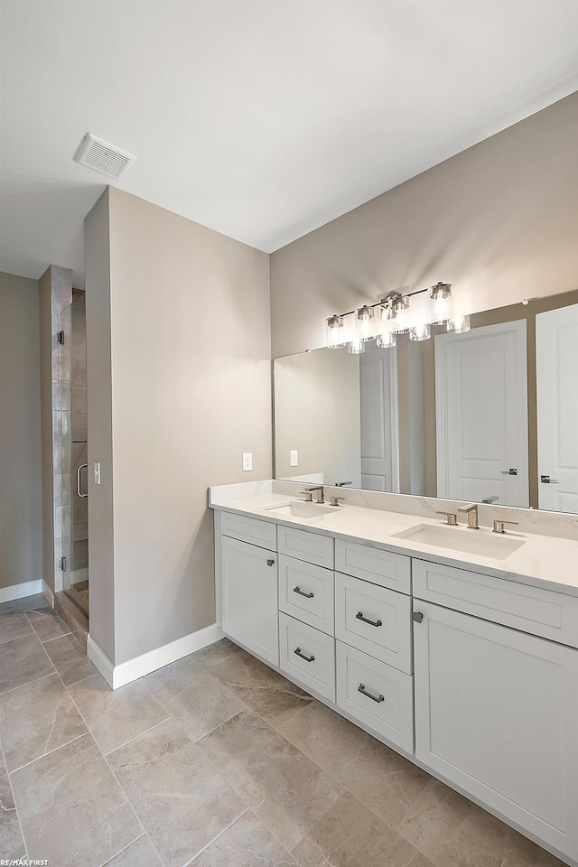 bathroom with vanity and a shower with door