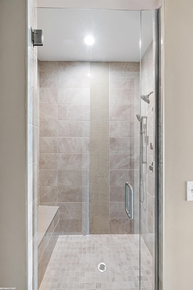 bathroom featuring a shower with door